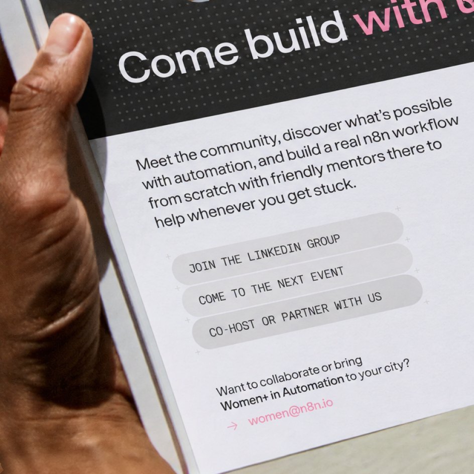 Hand holding a “Come build with us” flyer with a stack of capsules